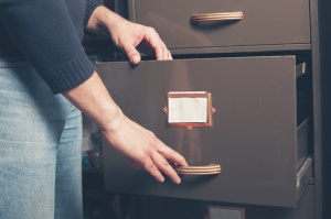 Man opening file cabinet